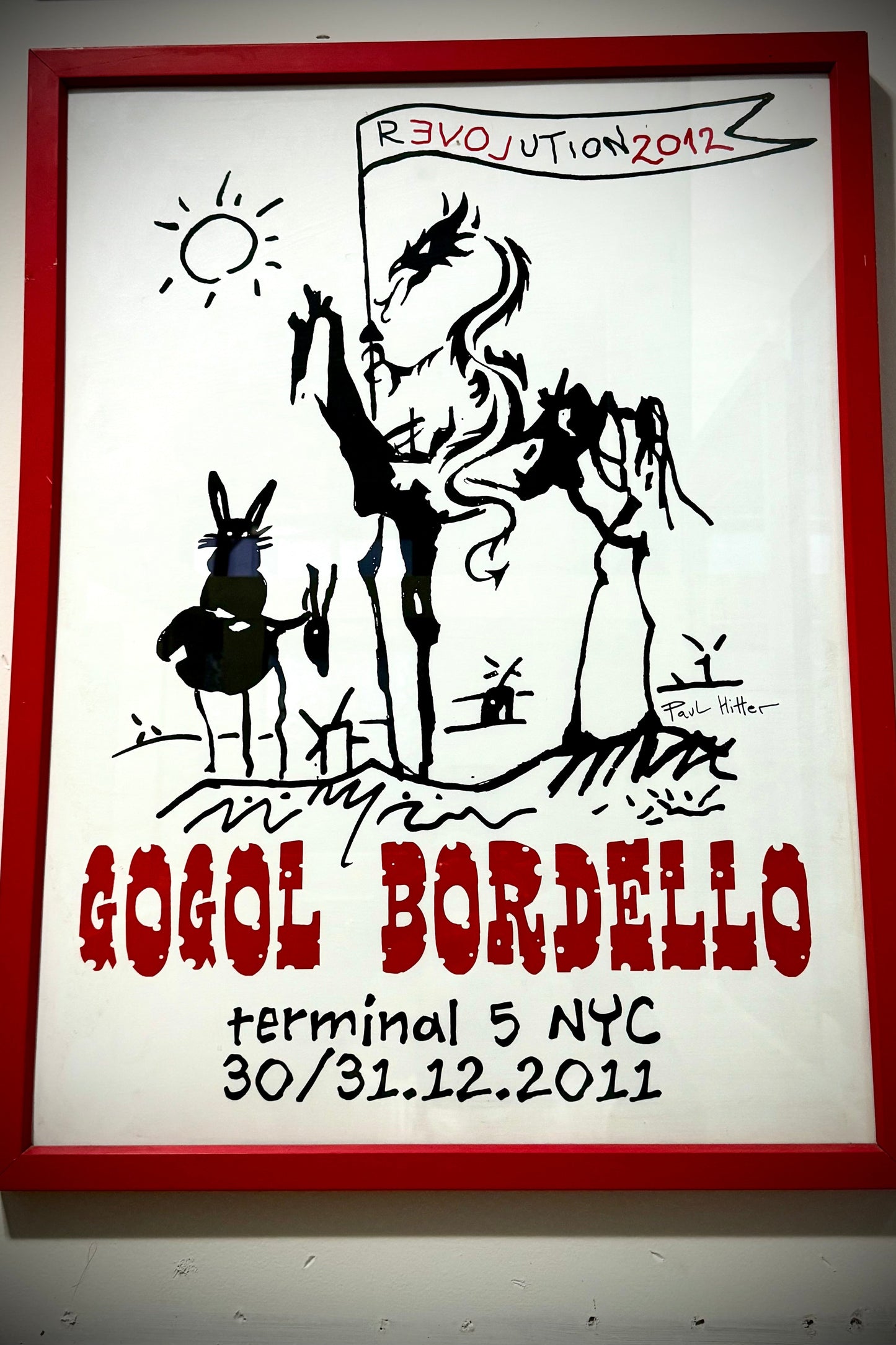 A framed poster featuring a black and white illustration with text 'GOGOL BORDELLO terminal 5 NYC 30/31.12.