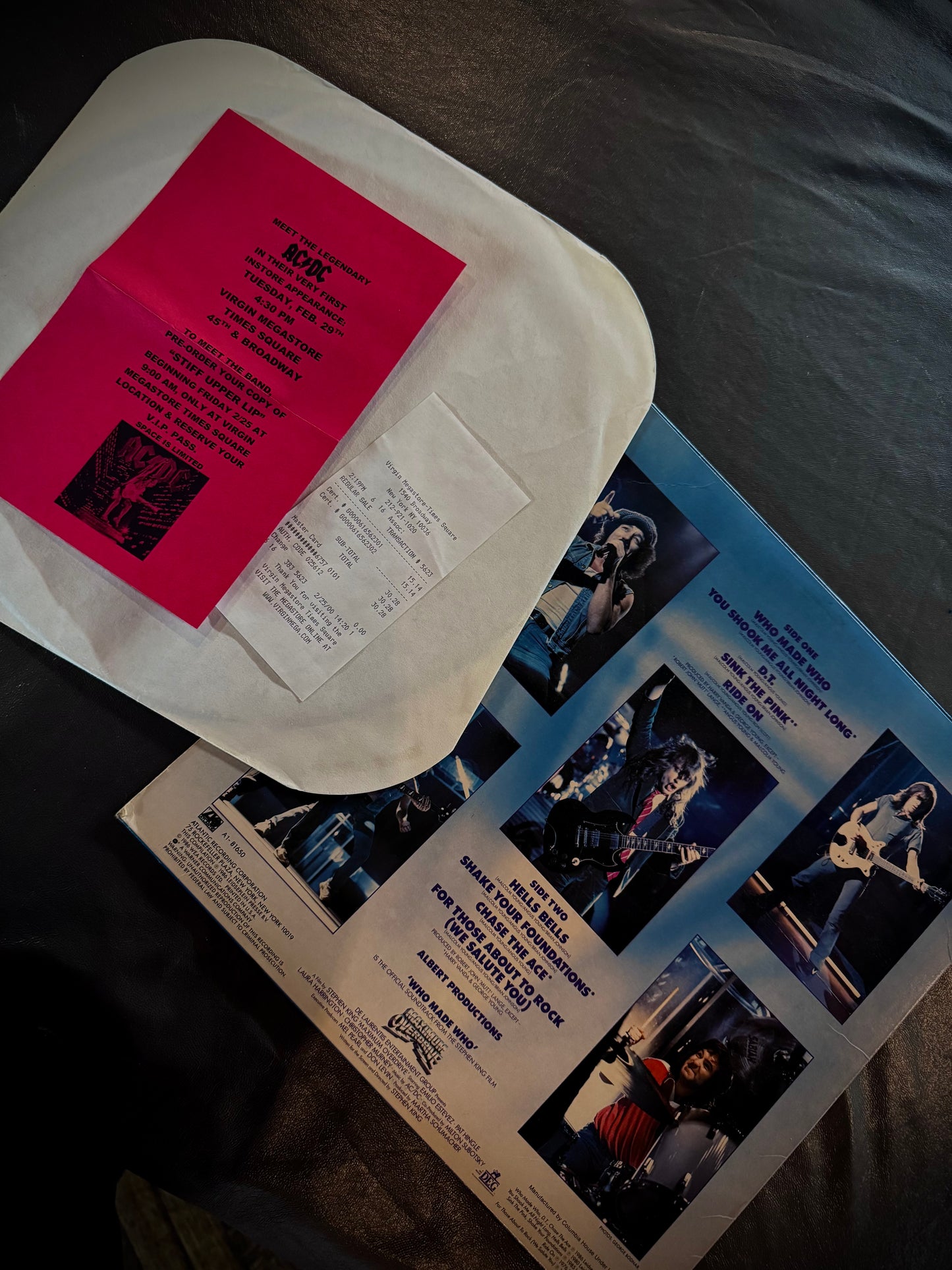 White container with pink paper on top of a magazine with images and text.