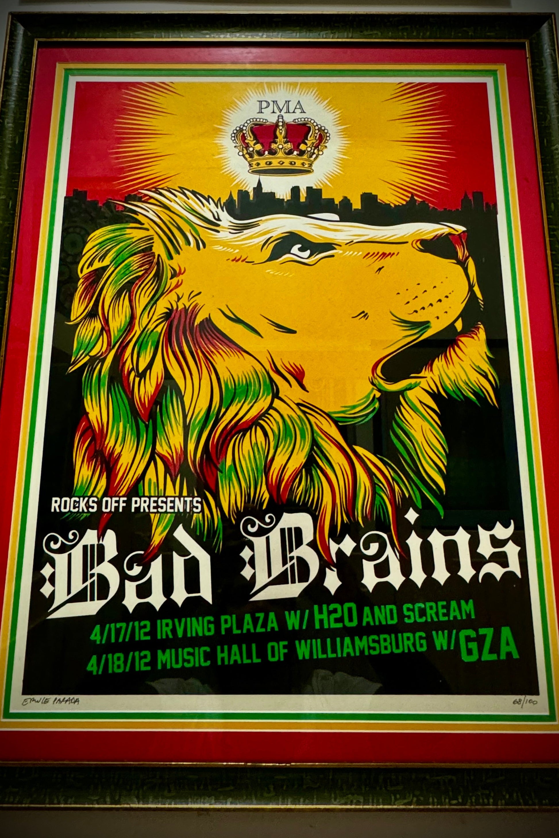 Framed concert poster featuring a stylized lion's head with a Rasta flag, text promoting a Bad Brains concert, and additional details about the event.