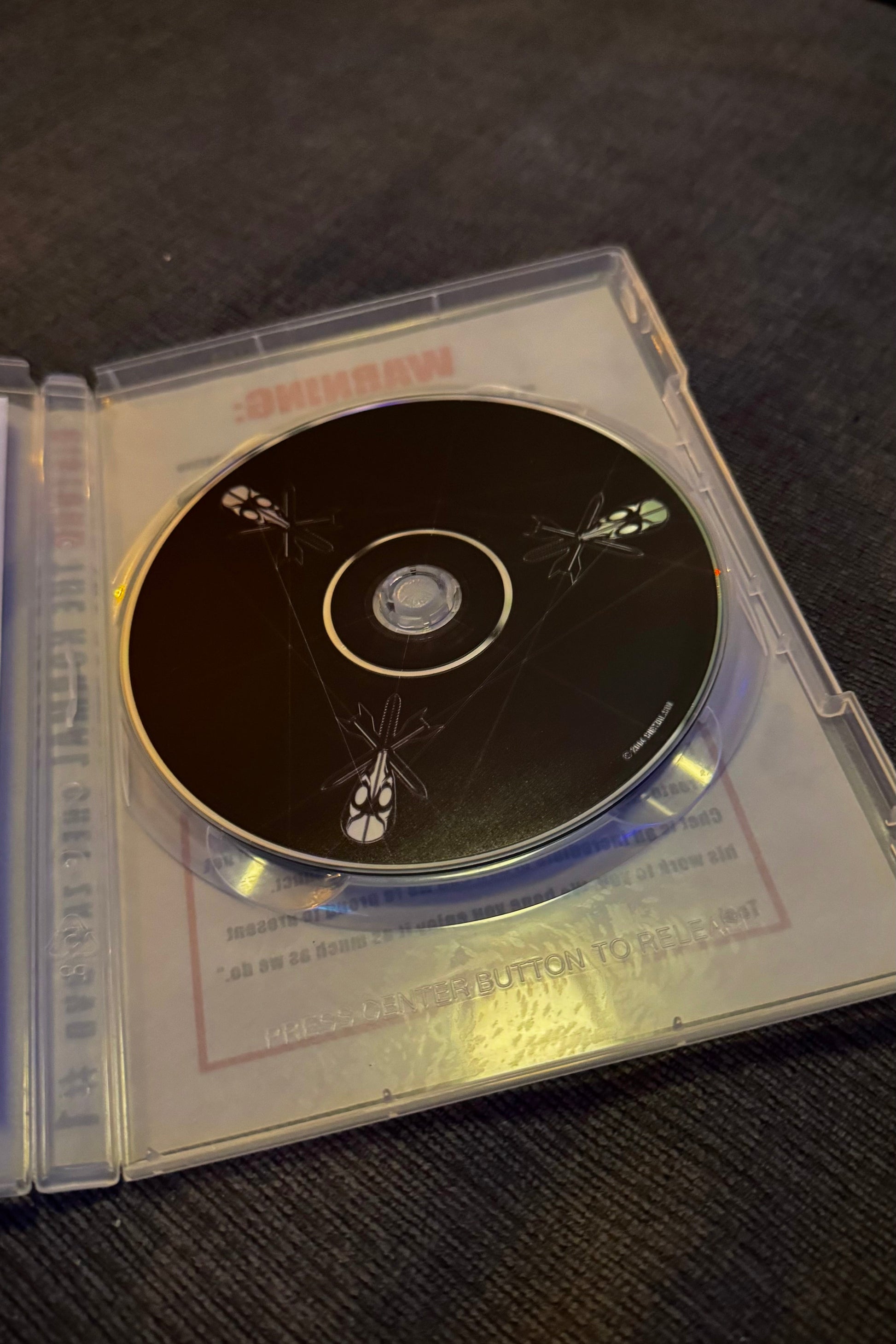 CD in a clear case on a dark surface