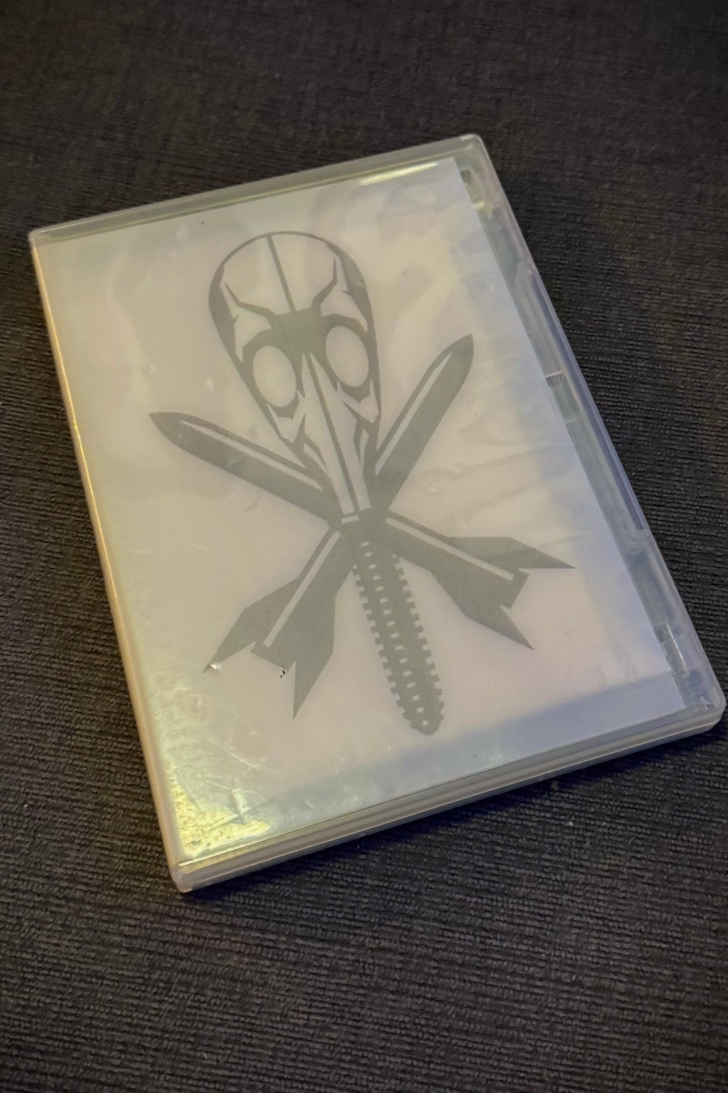 Clear plastic case with a logo on a dark textured surface