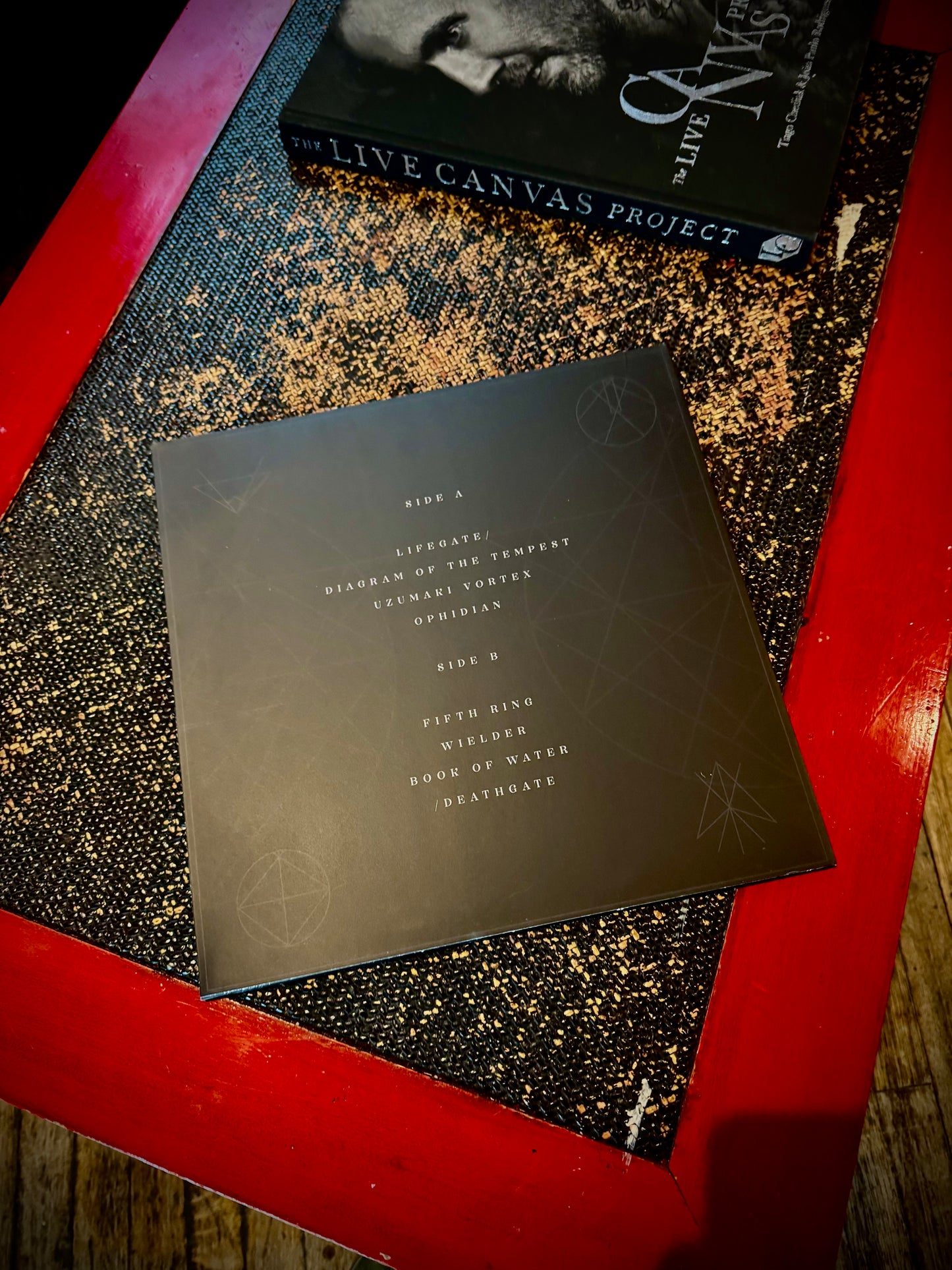A vinyl record titled 'Eagle Claw - Timing Of The Void' with a clear and black splatter design, displayed on a red surface.