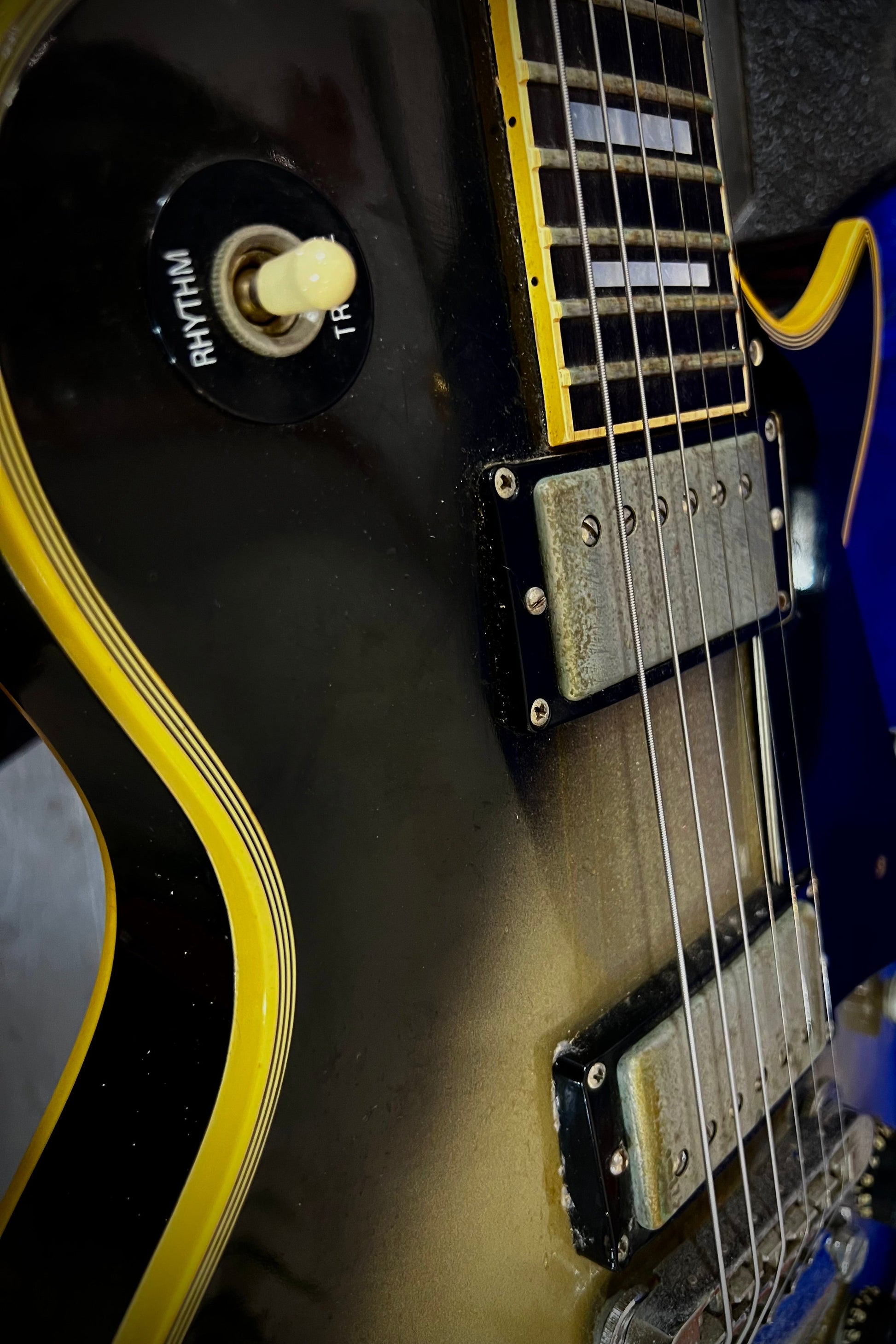 Close-up of an electric guitar with a blue background