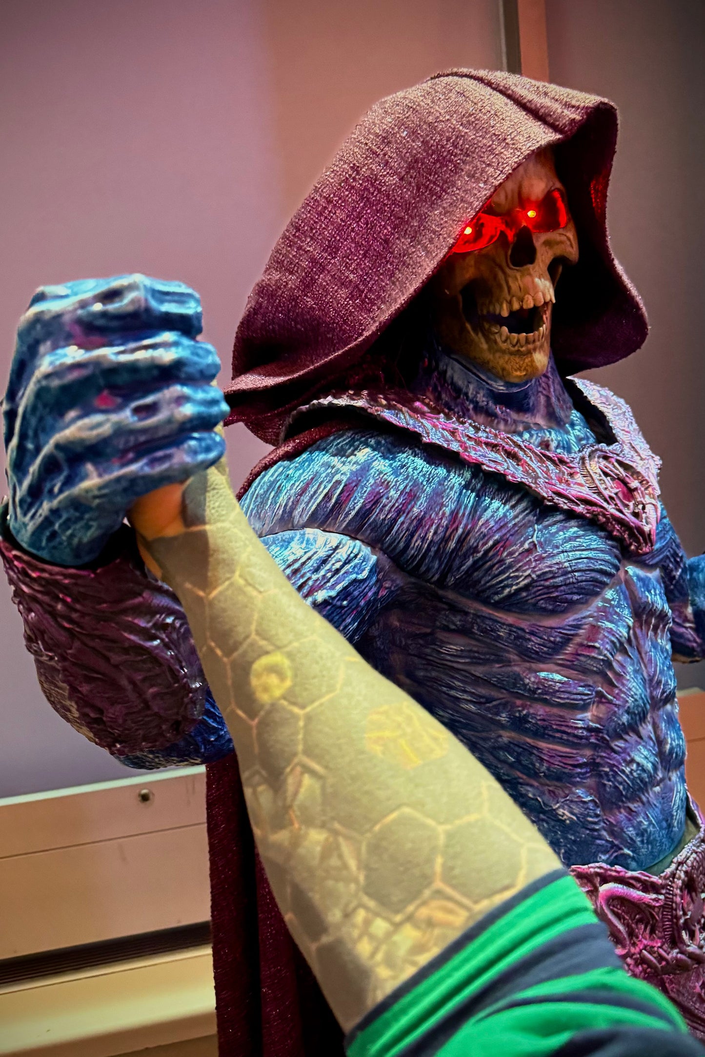 Costume character with glowing red eyes and colorful outfit