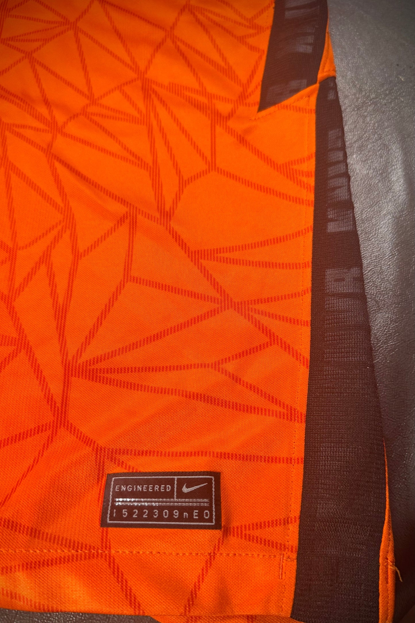 Orange fabric with a Nike label on a dark background
