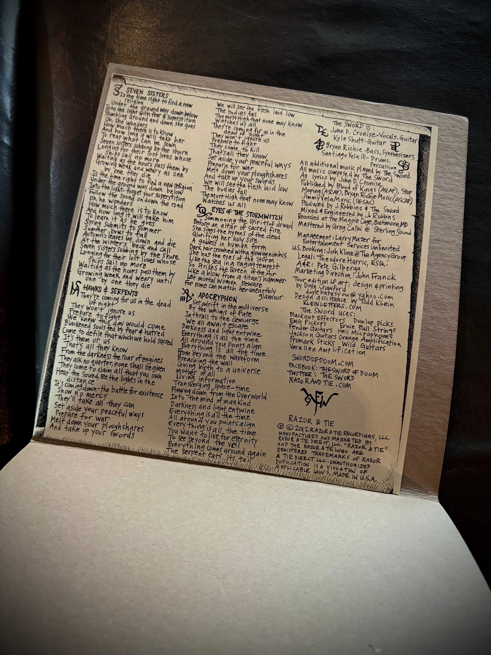 Open book with handwritten text on a dark background