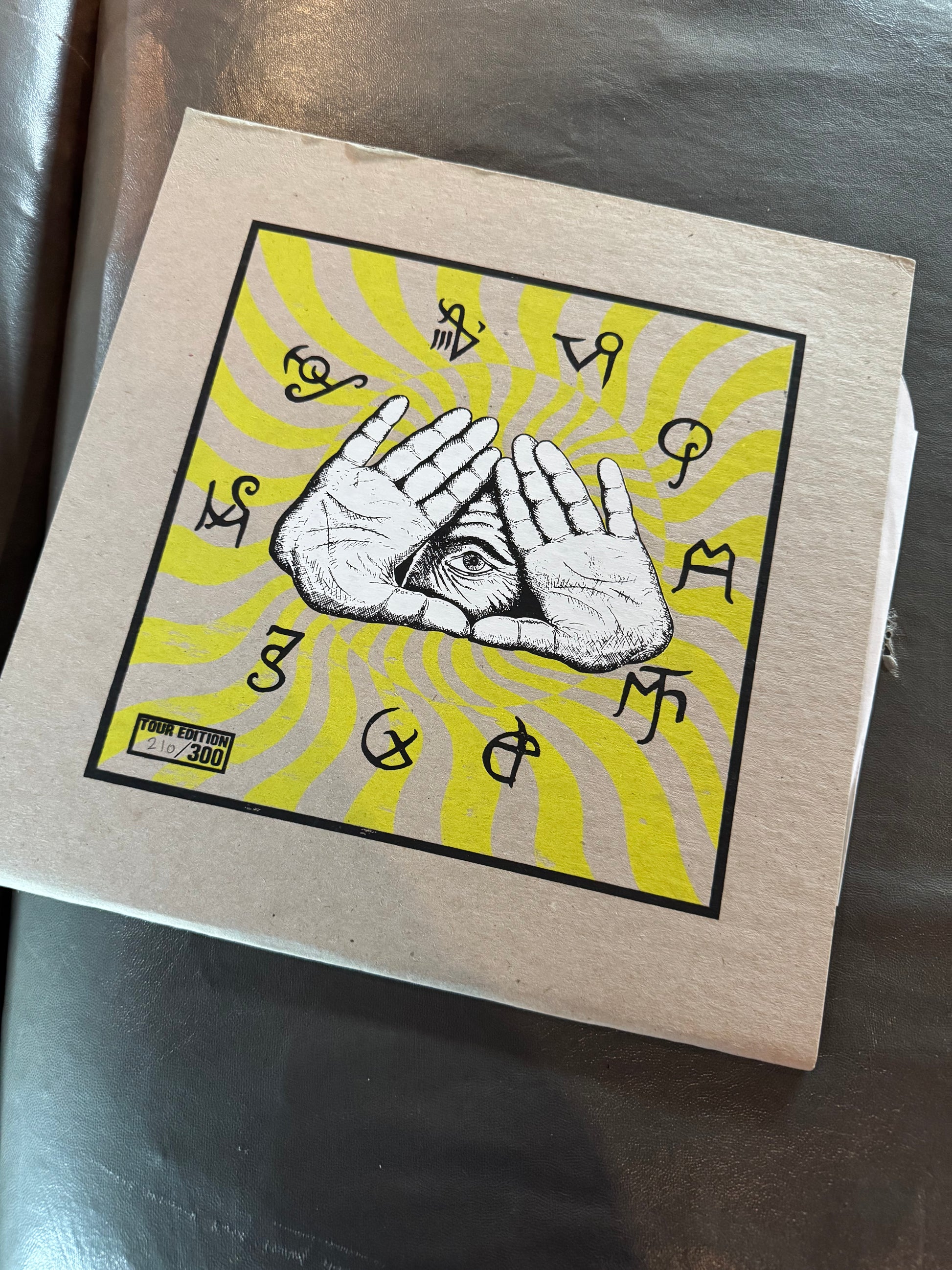 Book with a cover featuring hands and symbols on a yellow background
