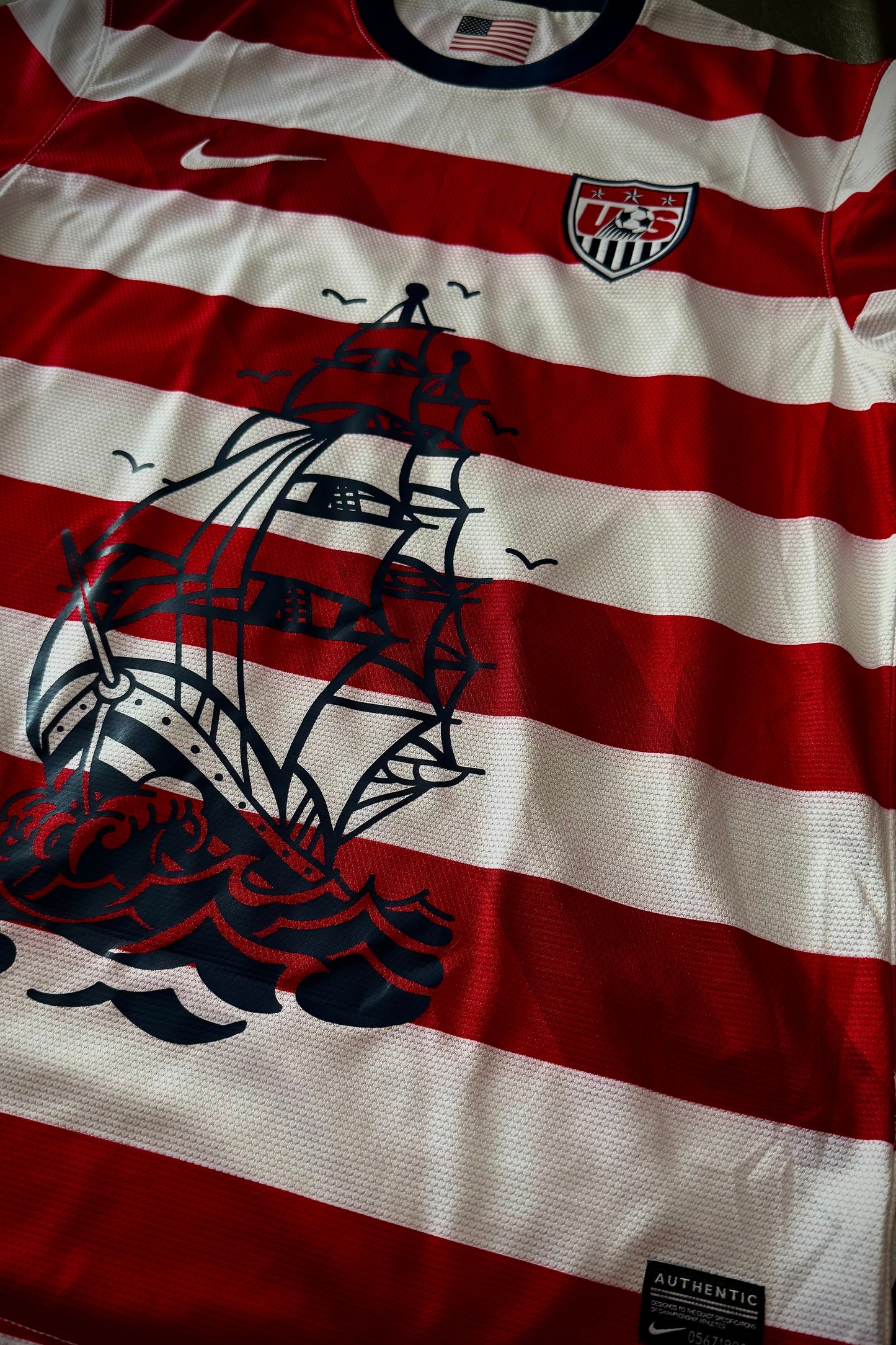 Red and white striped shirt with ship design and Nike logo